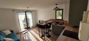 a living room with a kitchen with a table in it at Escale Cabourgeaise in Cabourg