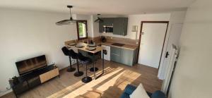 a kitchen with a table and chairs in a room at Escale Cabourgeaise in Cabourg