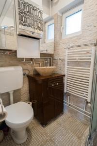a bathroom with a toilet and a sink at Ultra Central White & Lila Studio in Bucharest