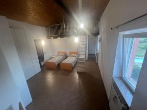 a small room with two beds and a staircase at Nido nel verde in Grazzano Visconti +18 photos