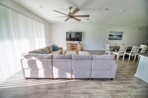 a living room with a couch and a ceiling fan at A Getaway Home in The Clouds in Pine Grove