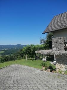 a stone road next to a building with a table and chairs at Cozy vacation house in Gabrovka