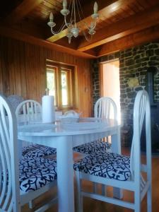 a white table and chairs in a room at Cozy vacation house in Gabrovka