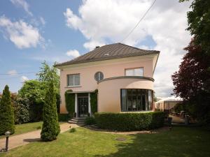 a yellow house with a black roof at B&B "Villa Fink" in Ostheim