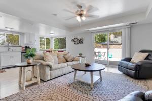 a living room with a couch and a table at Oasis Condo on the Fairway in Victorville