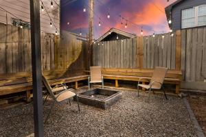 a patio with three chairs and a fire pit at Casa Hosum - 7 mins Downtown Sleeps 9 King Bed Fenced Yard in Houston