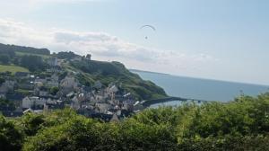 a small town on a hill next to the ocean at Logis proche des plages du débarquement in Vaucelles +7 photos
