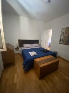 a bedroom with a blue bed and a wooden floor at Casa blu in Rapolano Terme
