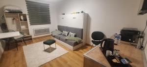 a living room with a couch and some chairs at L'Eldorado du Léman in Annemasse