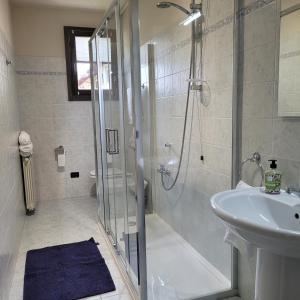 a bathroom with a shower and a sink at Confylake Home in Pisogne +12 photos