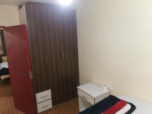a bedroom with a large brown door and a bed at Micasa Homes BNB in Kihingo +4 photos
