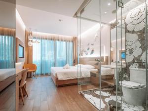 a bedroom with a bed and a glass shower at A Hotel Bugis in Singapore
