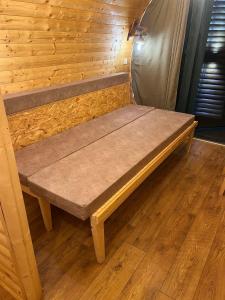 a wooden bench sitting on the floor of a room at Bungalows Tea Žabljak in Žabljak