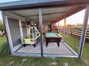 a play room with a pool table in it at Park Jesionów domki - Pleśna in Pleśna