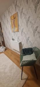 a room with a chair and a picture of a cowboy at L'Eldorado du Léman in Annemasse +2 photos