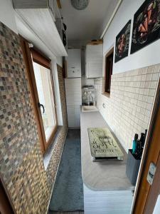 two pictures of a small bathroom with a sink at Jules Cozy Place in Bucharest