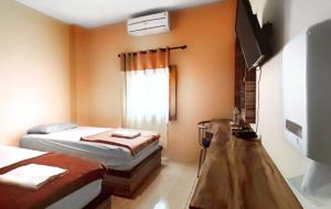 Postelja oz. postelje v sobi nastanitve Hotel Syariah Larismanis