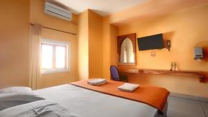 Postelja oz. postelje v sobi nastanitve Hotel Syariah Larismanis