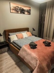 a bedroom with a bed with towels on it at Apartament Lux Gdańsk Nowa Motława in Gdańsk