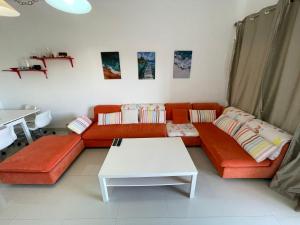 a living room with a couch and a table at VIP Chalet Amwaj North Cost E Zone The Terrace in El Alamein