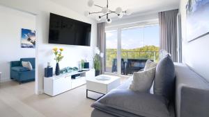 Televízia a/alebo spoločenská miestnosť v ubytovaní Apartamenty Sun & Snow Polanki Aqua z basenem