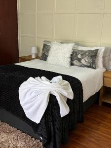 a bedroom with a bed with a white towel on it at The Private Place in Witbank