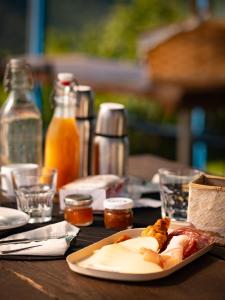 a wooden table with a plate of food on it at Yurte in Langa in Bosia