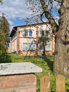 eine blaue Schaukel vor einem Haus in der Unterkunft Landhaus am Bauernhof im Ostseeland in Boldenshagen