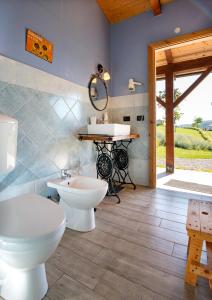 a bathroom with a toilet and a sink at Yurte in Langa in Bosia