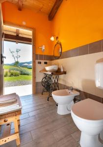 a bathroom with two toilets and a sink at Yurte in Langa in Bosia +37 photos