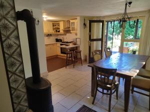 a kitchen and dining room with a wood stove at RichiLak in Visegrád +19 photos