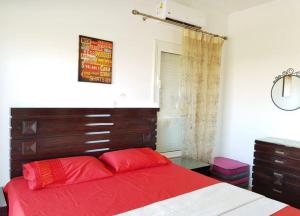 a bedroom with a red bed with a wooden headboard at VIP Chalet Amwaj North Cost E Zone The Terrace in El Alamein