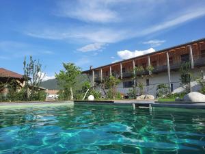 a swimming pool in front of a building at Lerchnhof in Valdaora