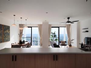 a kitchen and living room with a table and chairs at Lumi Tropicana in Petaling Jaya +108 photos