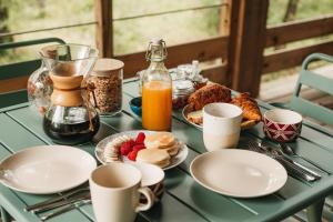 a table topped with plates of breakfast foods and coffee at Côte & Lodge in Talais +22 photos