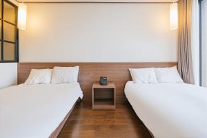 Postel nebo postele na pokoji v ubytování Tamara Jeju hotel