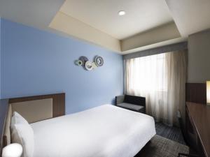 ibis Styles Kyoto Shijo客房内的一张或多张床位