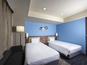 ibis Styles Kyoto Shijo客房内的一张或多张床位