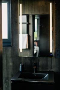 a bathroom with a sink and a mirror at Neugrad STYLE - 2er Cabins in Schleiden +34 photos