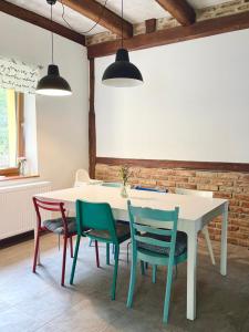 a dining room with a white table and chairs at Na Bukovku in Těchlovice +34 photos