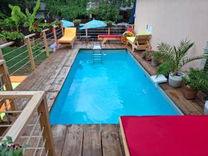 a swimming pool on a deck with chairs and a table at Casa Marronne in Costinesti