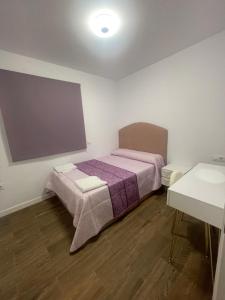 a small room with a bed in a room at Casa luna in Chiclana de la Frontera +9 photos