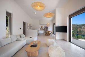 a living room with a couch and a table at Villa Eptanisa in Sivota