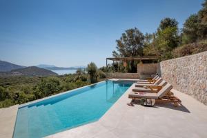 a villa with a swimming pool with a view at Villa Eptanisa in Sivota