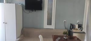 a living room with a couch and a table at Studios Akrotiri in Mytilene