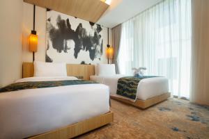 Postel nebo postele na pokoji v ubytování Louis Kienne Cikarang Hotel & Service Apartment