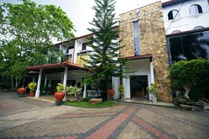 a building with a tree in front of it at Blue Lotus Garden Hotel piliyandala in Colombo