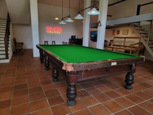 a pool table in the middle of a room at Pinnacle of Everything in Kandy