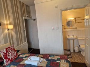 a hotel room with a bed and a bathroom at Stafford House in Blackpool