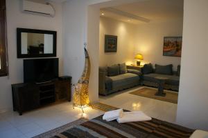 a living room with a couch and a television at Dar Tahra in Casablanca